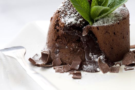 Delicious chocolate pie filled with warm fluid chocolate mouse and decorated with mint and chocolate sprinkles
