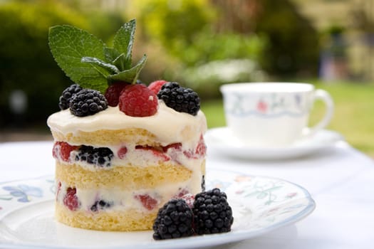 Beautifully decorated dessert served outdoors on a plate in the garden