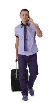 Image of a young casual man with suitcase and mobile phone.