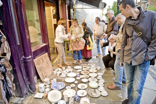 Tourists on one of streets of London buy souvenirs 