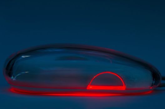 Image shows an optical mouse in a low light surroundings