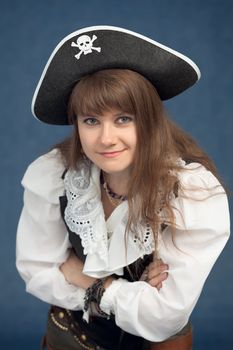 Portrait of pirate woman in hat on blue background