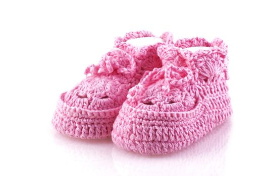 Cute pink baby footwear on a white background.