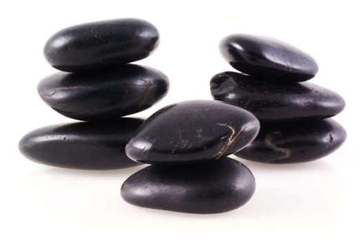 Three piles of zen stones on a white background.              