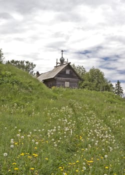 Small rural wooden church on the hill