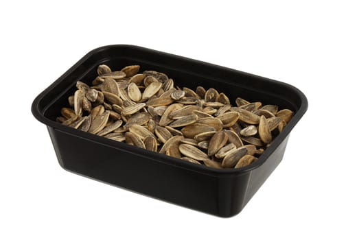 Dried and salted sunflower seeds in plastic bowl isolated on white background