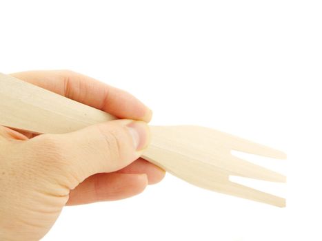 Person holding a wooden spatula fork, isolated towards white background