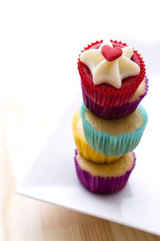 top view of some small cupcake in colorful cup place one on top of the other to create a column with a top cupcake with valentine inspire decoration