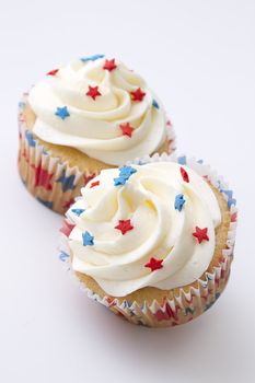 4th of july cupcake decorated with red and blue star and white frosting