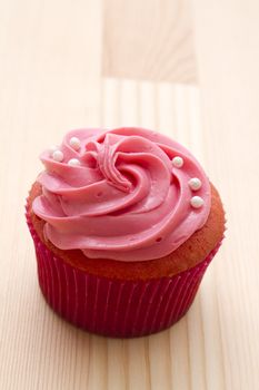 cupcake with melted pink frosting and white pearls