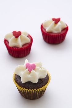 bite size cupcake decorated with white frosting and candy heart