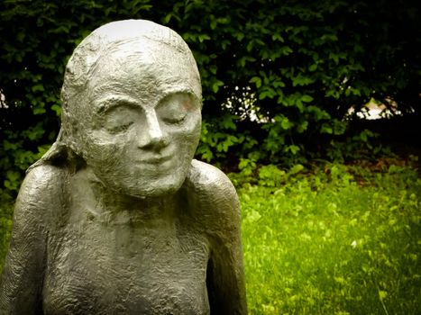 Statue of a girl with a different look on her face.
