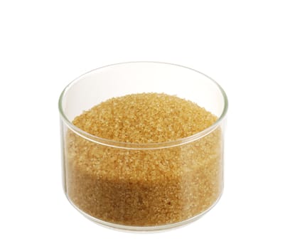 Brown sugar ( golden demerara) in glass bowl isolated on white background