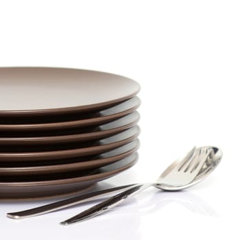 Stack of brown round plates with spoon and fork (with sample text)