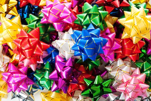 Large heap of colorful decorative bows 