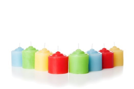 Colorful short candles without flame. Isolated over white background