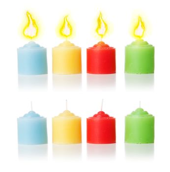 4 colorful candles with candlelight and without it. Isolated over white background