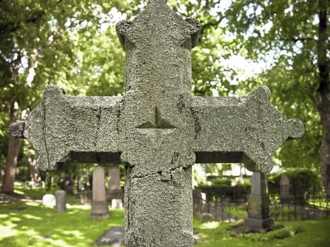 Old Stone cross in a christian cemetery