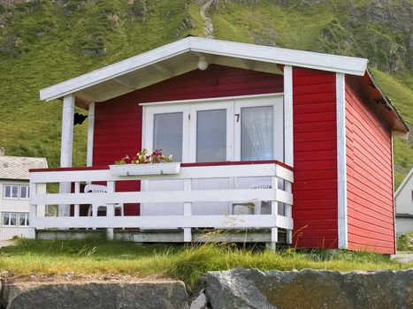 Norwegian red cottage in mountain landscape