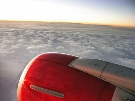 Airplane engine during a fly in sunset sky