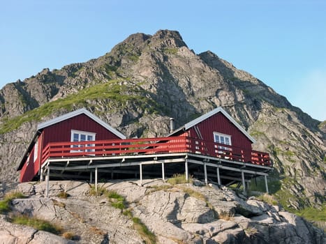 Two wooden red cottage on the mountain, Norway, Lofoten