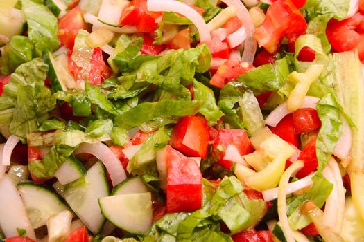 Vegetable allsorts from salad, tomatoes, cucumbers, and the onions, filled in with oil