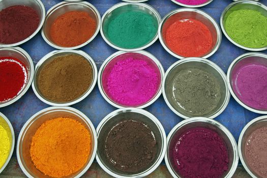 Colored powders for sale at a market outside a Hindu temple. Orchha, Madhya Pradesh, India