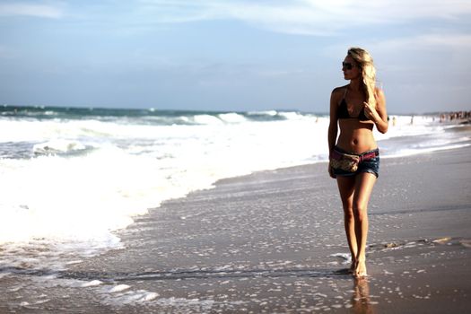 girl walking in the ocean waves