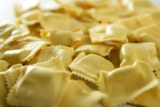 Cheese filled Italian yellow pasta texture, white background