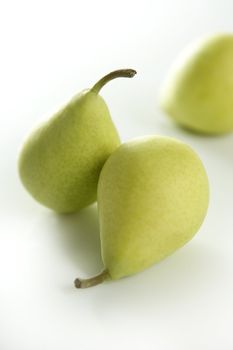 Three pears on white studio background, selective focus