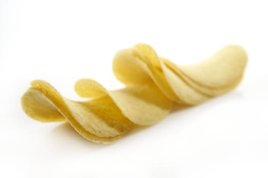 Potato salted chips slices over white background