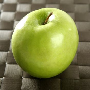 Sweet fruit, apples on a brown tablecloth