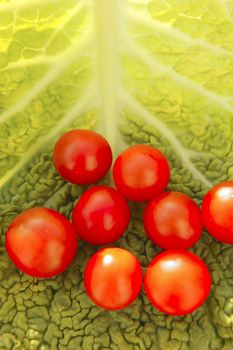 Raw vegetables still with cherry tomatoes and cabbage leaf