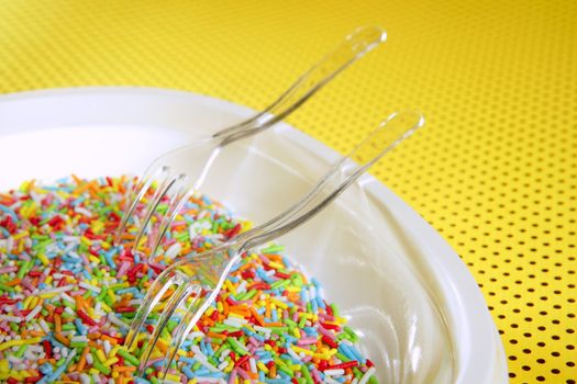 Colorful little sweet candy plate with fork, children delice