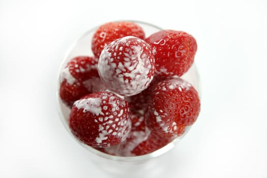 Glass full of delicious Strawberries and liquid cream