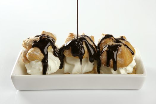 Delicious and addictive cream puff cake dessert with chocolate syrup