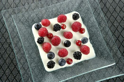 Dessert of mixed and varied berries and cream