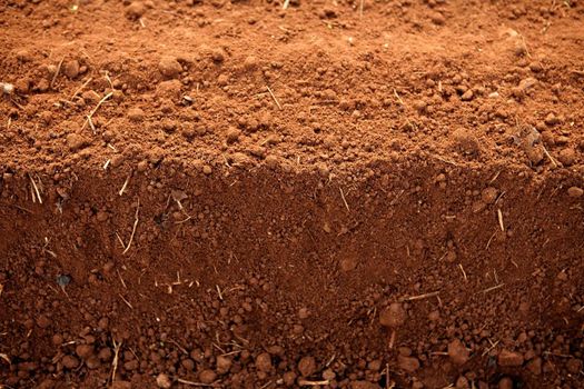 Ploughed red clay soil agriculture fields ready to sow