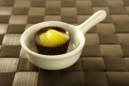 Varied pastries over spoon. Little colorful cakes