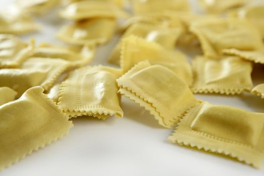 Cheese filled Italian yellow pasta texture, white background