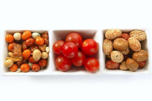 Long triple bowl with varied japanese snacks and tomatoes