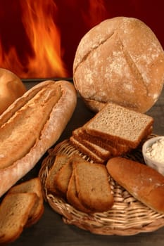 Bread still life with varied shapes and bakery fire in background