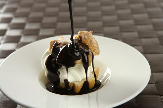 Delicious and addictive cream puff cake dessert with chocolate syrup