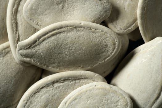 white dried pumpkin seeds in a crop macro studio shot