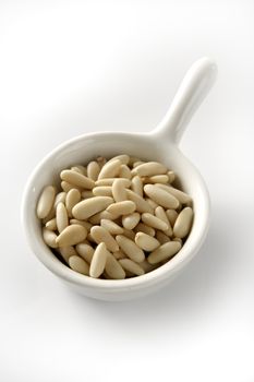Abundant pine nuts in a close-up view, white background