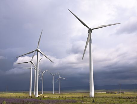 Wind turbines generating electricity in a stormy weather.