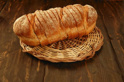 Golden sliced bread classic still over dark wood background