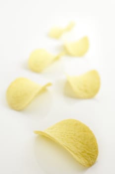 Potato salted chips slices over white background