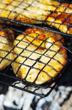 fresh salmon fillet cooking on barbecue.