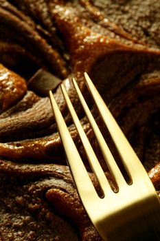 Chocolate cake crop macro texture, golden light, studio shot